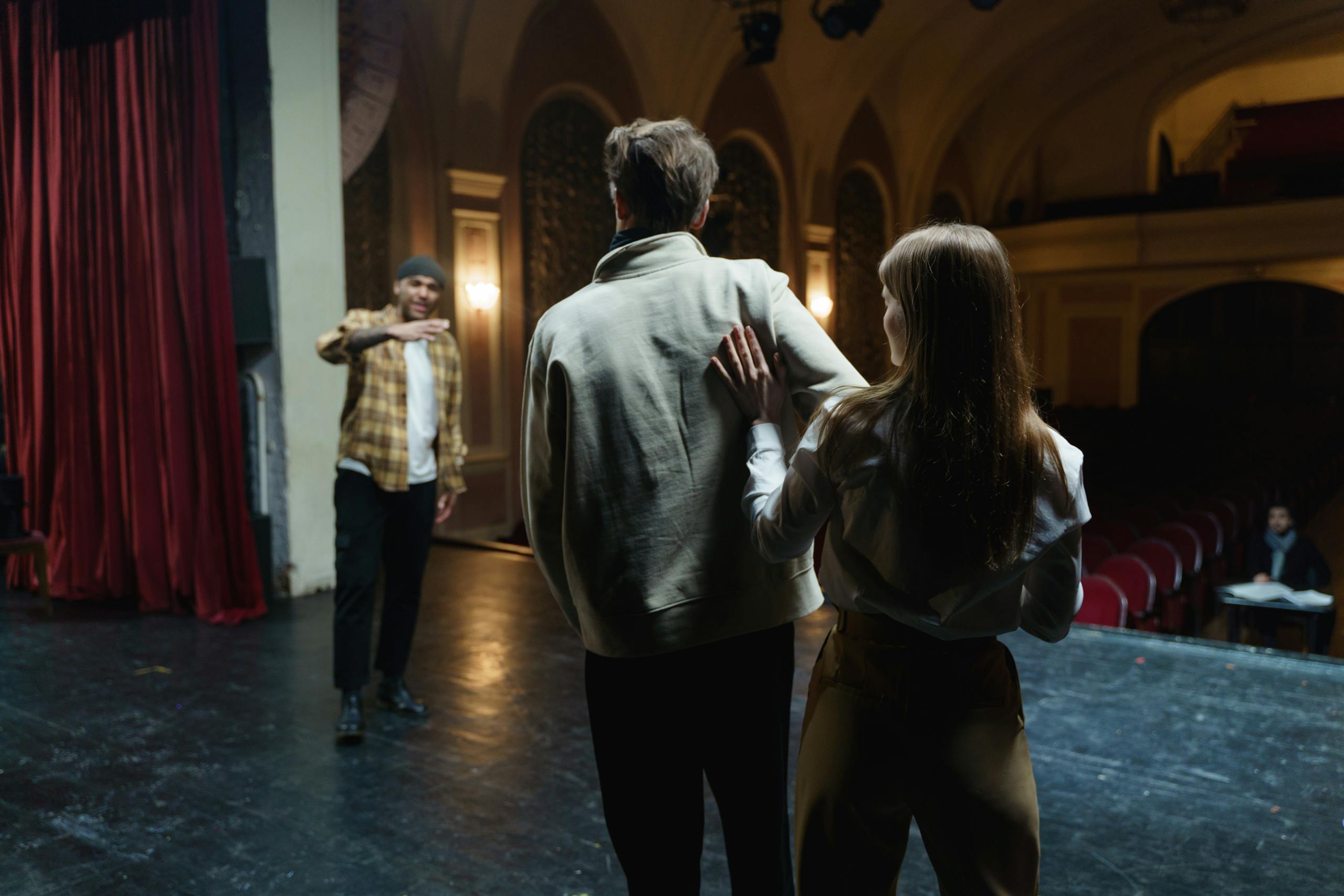 Actors in rehearsal on stage, capturing the art and emotion of theater.